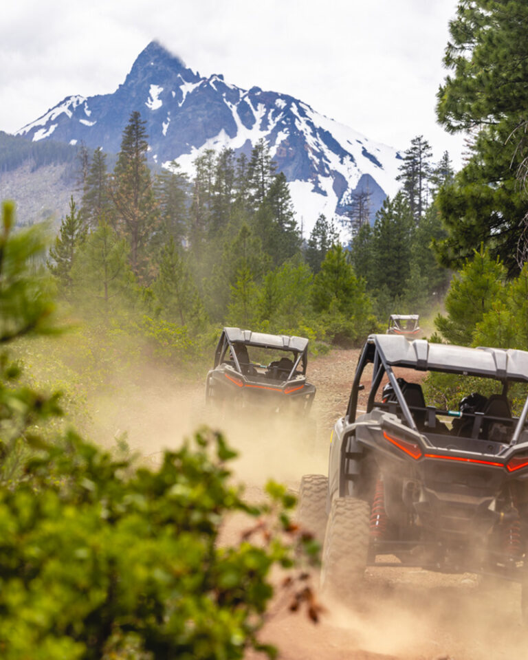 Visit Bend. ATVs on a dirt road with a view of Mt. Jefferson near Bend, OR. 15 Oct. 2025.